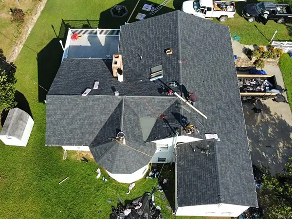Crew installing new shingles on roof